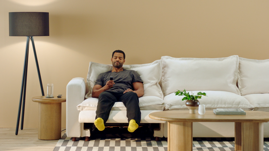 A man is sitting on the couch