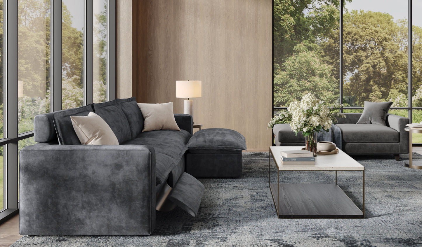 Charcoal reclining sectional with beige accents in sunlit corner featuring modern marble coffee table and ambient table lamp